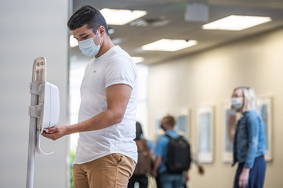 Students use hand sanitizer on campus to stay safe and healthy.