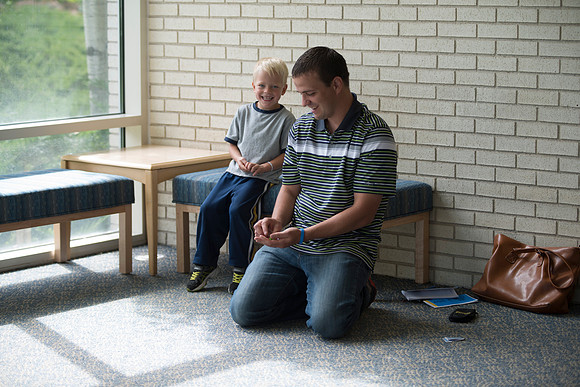Father watches son while waiting for wife.