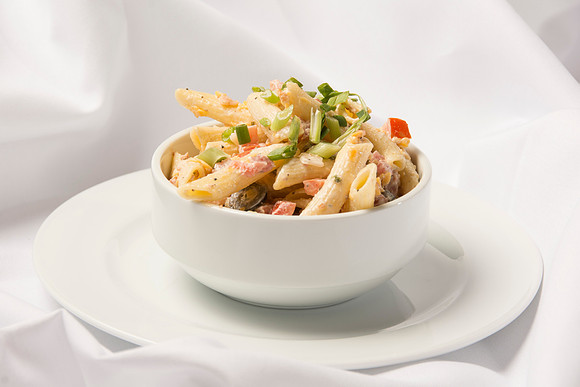 A tender Penne Pasta mixed with crispy bacon, ranch dressing, diced tomatoes, sliced olives and shredded cheese.