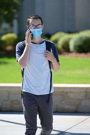 Student volunteers show the way to stay safe during this COVID 19 pandemic by social distancing, following pathway arrows and proper wearing of masks .