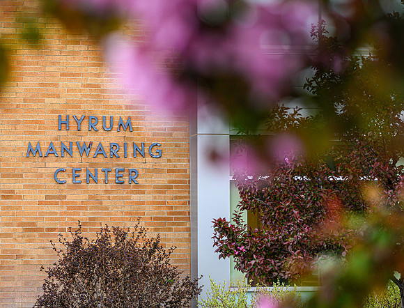 The Manwaring Student Center framed by blossoms in the early morning.