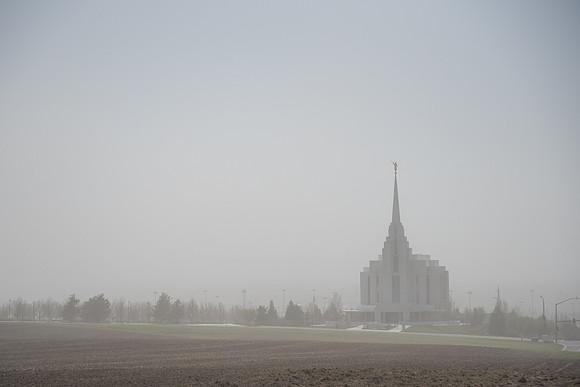 Rexburg Idaho Temple surrounded by dust during a wind storm.