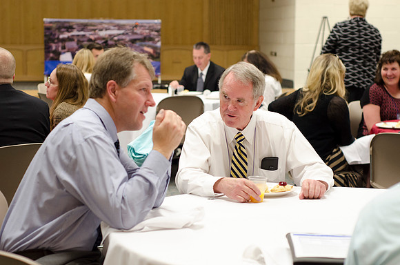 Online instructors gather for breakfast and instruction.