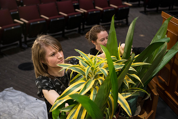 Floral Design students, Lauren Smith and Margaret Setterstrom create a beautiful floral arrangement in front of the podium for devotional.