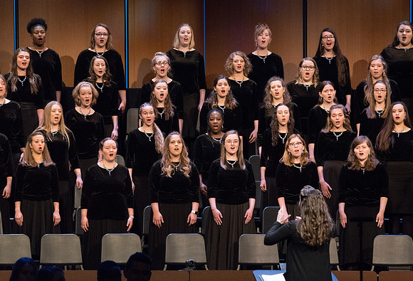 A woman's choir comprised of students sing at a BYU-Idaho Devotional in Spring 2019.