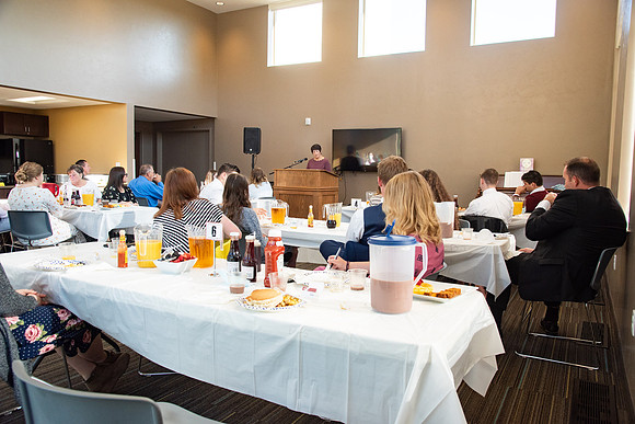 Faculty and Staff of Housing and Student Living gather for an early morning breakfast and an inspirational speaker.