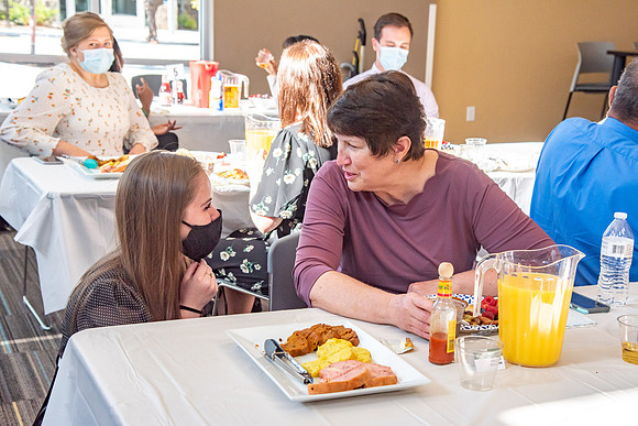 Faculty and Staff of Housing and Student Living gather for an early morning breakfast and an inspirational speaker.