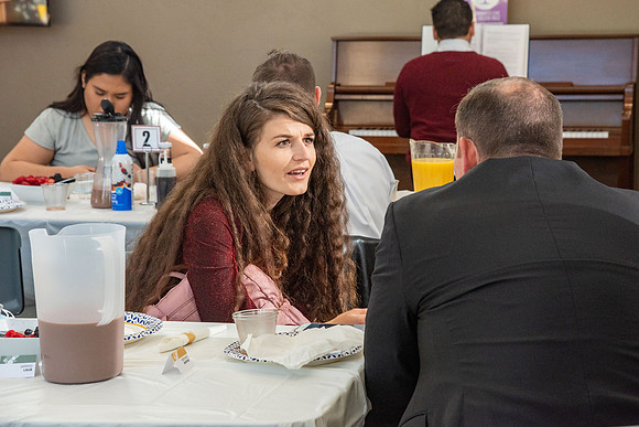 Faculty and Staff of Housing and Student Living gather for an early morning breakfast and an inspirational speaker.