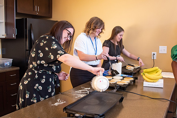 Faculty and Staff of Housing and Student Living gather for an early morning breakfast and an inspirational speaker.