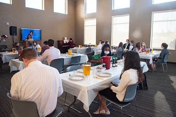 Faculty and Staff of Housing and Student Living gather for an early morning breakfast and an inspirational speaker.