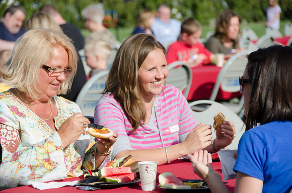 Online instructors gather with their families for an eveing of BBQ and games.