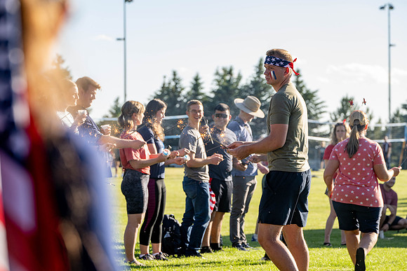 Students gather at the upper field for various 4th of July activities.