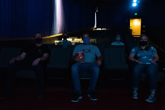 Students at a local movie theater wearing face masks.