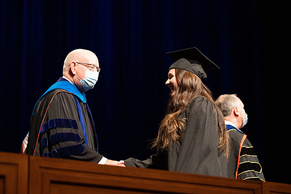 Combined Convocation for the College of Business & Communication and also the College of Physical Sciences & Engineering. Graduates receive their diploma covers.