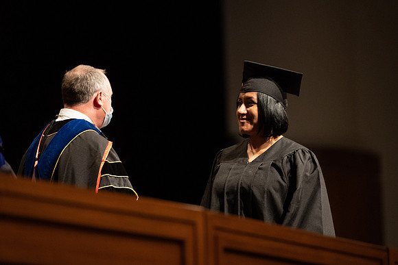 Combined Convocation for the College of Business & Communication and also the College of Physical Sciences & Engineering. Graduates receive their diploma covers.