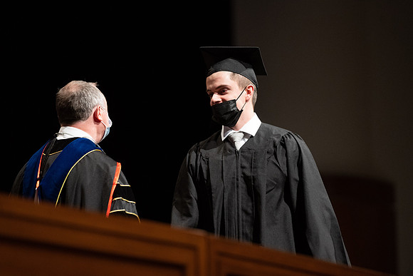 Combined Convocation for the College of Business & Communication and also the College of Physical Sciences & Engineering. Graduates receive their diploma covers.