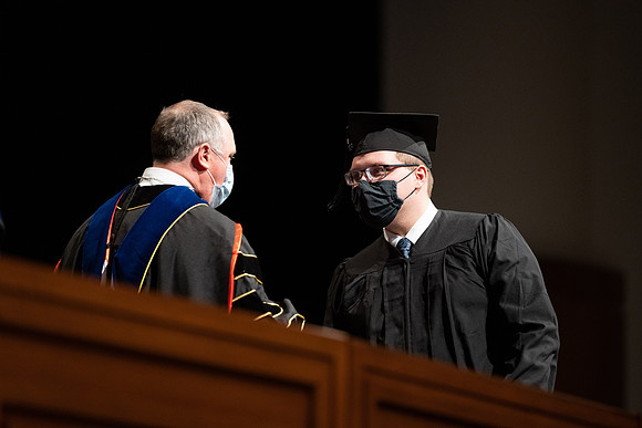 Combined Convocation for the College of Business & Communication and also the College of Physical Sciences & Engineering. Graduates receive their diploma covers.