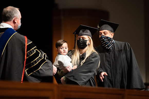 Combined Convocation for the College of Business & Communication and also the College of Physical Sciences & Engineering. Graduates receive their diploma covers.