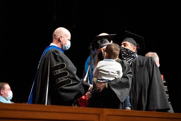 Combined Convocation for the College of Business & Communication and also the College of Physical Sciences & Engineering. Graduates receive their diploma covers.
