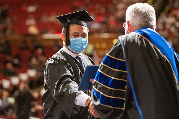 Combined Convocation for the College of Business & Communication and also the College of Physical Sciences & Engineering. Graduates receive their diploma covers.