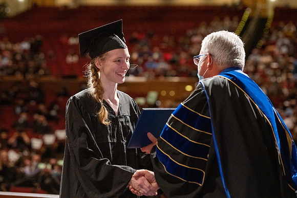 Combined Convocation for the College of Business & Communication and also the College of Physical Sciences & Engineering. Graduates receive their diploma covers.