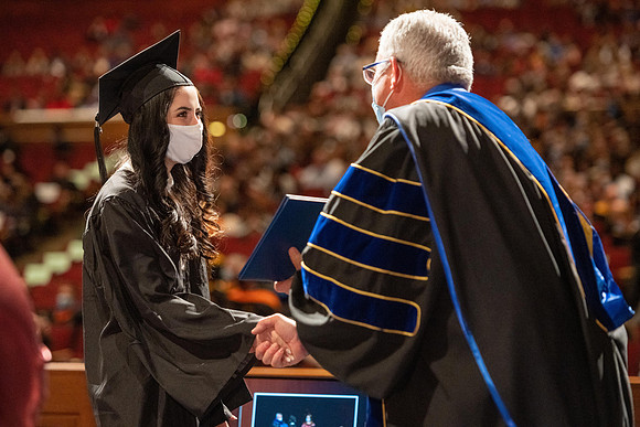 Combined Convocation for the College of Business & Communication and also the College of Physical Sciences & Engineering. Graduates receive their diploma covers.