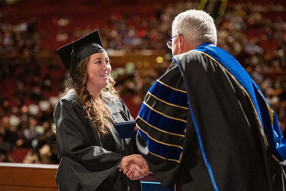 Combined Convocation for the College of Business & Communication and also the College of Physical Sciences & Engineering. Graduates receive their diploma covers.