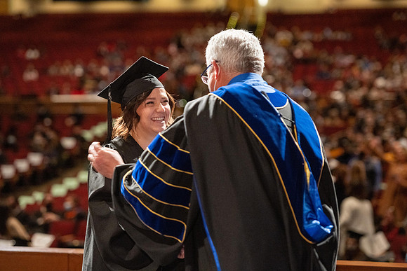 Combined Convocation for the College of Business & Communication and also the College of Physical Sciences & Engineering. Graduates receive their diploma covers.
