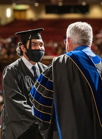 Combined Convocation for the College of Business & Communication and also the College of Physical Sciences & Engineering. Graduates receive their diploma covers.