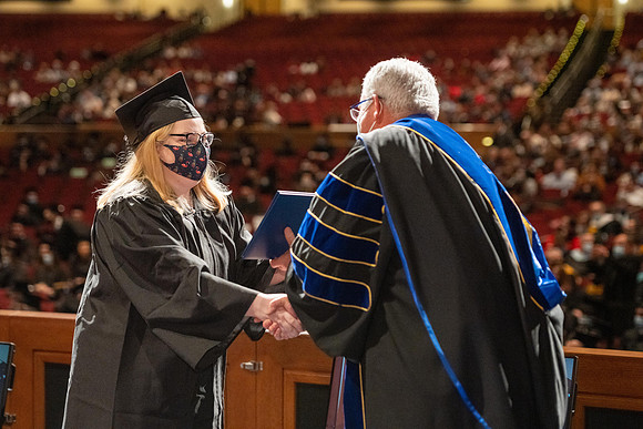 Combined Convocation for the College of Business & Communication and also the College of Physical Sciences & Engineering. Graduates receive their diploma covers.