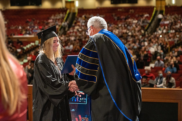 Combined Convocation for the College of Business & Communication and also the College of Physical Sciences & Engineering. Graduates receive their diploma covers.