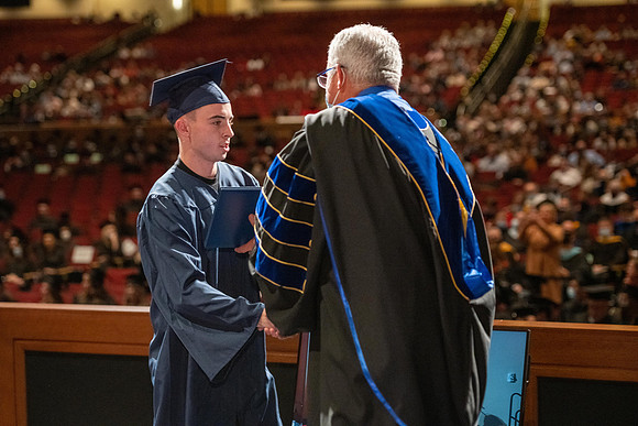 Combined Convocation for the College of Business & Communication and also the College of Physical Sciences & Engineering. Graduates receive their diploma covers.