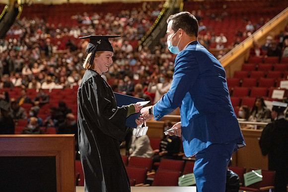 Combined Convocation for the College of Business & Communication and also the College of Physical Sciences & Engineering. Graduates receive their diploma covers.