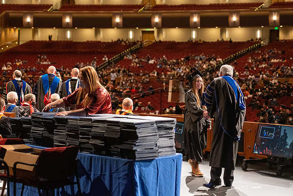 Combined Convocation for the College of Business & Communication and also the College of Physical Sciences & Engineering. Graduates receive their diploma covers.