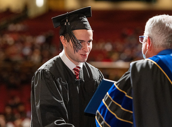 Combined Convocation for the College of Business & Communication and also the College of Physical Sciences & Engineering. Graduates receive their diploma covers.