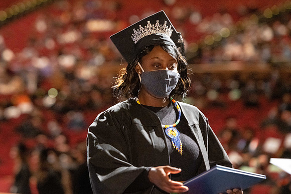 Combined Convocation for the College of Business & Communication and also the College of Physical Sciences & Engineering. Graduates receive their diploma covers.
