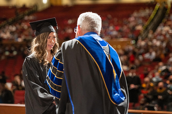 Combined Convocation for the College of Business & Communication and also the College of Physical Sciences & Engineering. Graduates receive their diploma covers.
