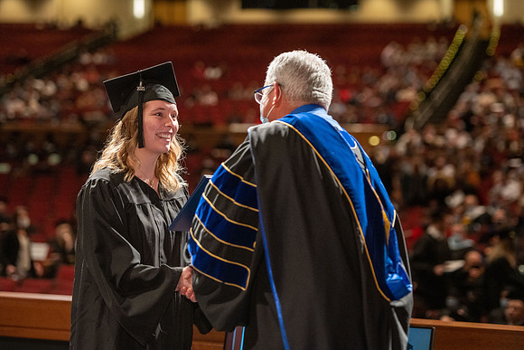 Combined Convocation for the College of Business & Communication and also the College of Physical Sciences & Engineering. Graduates receive their diploma covers.