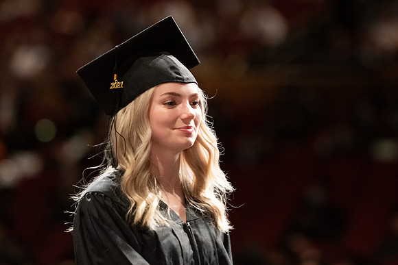 Combined Convocation for the College of Business & Communication and also the College of Physical Sciences & Engineering. Graduates receive their diploma covers.