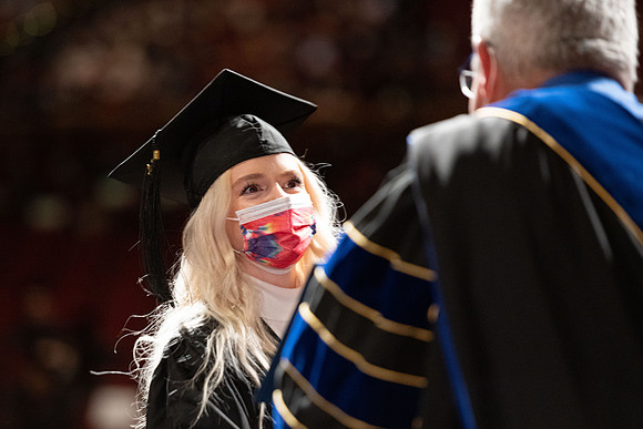 Combined Convocation for the College of Business & Communication and also the College of Physical Sciences & Engineering. Graduates receive their diploma covers.