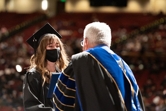 Combined Convocation for the College of Business & Communication and also the College of Physical Sciences & Engineering. Graduates receive their diploma covers.