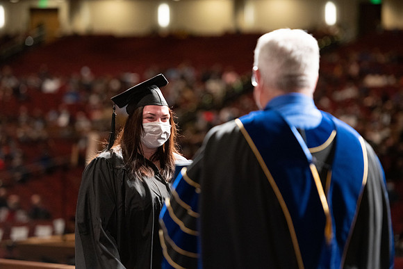 Combined Convocation for the College of Business & Communication and also the College of Physical Sciences & Engineering. Graduates receive their diploma covers.