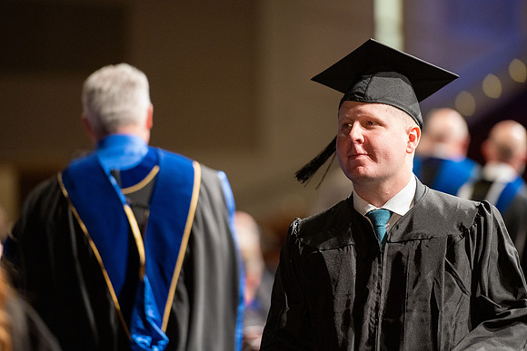 Combined Convocation for the College of Business & Communication and also the College of Physical Sciences & Engineering. Graduates receive their diploma covers.