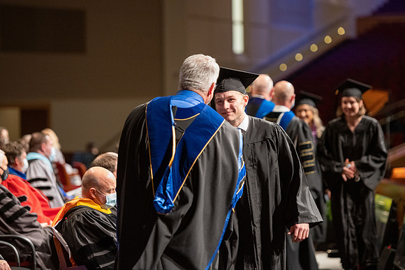 Combined Convocation for the College of Business & Communication and also the College of Physical Sciences & Engineering. Graduates receive their diploma covers.