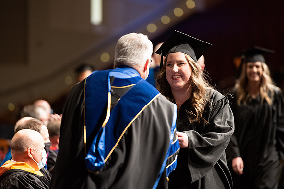 Combined Convocation for the College of Business & Communication and also the College of Physical Sciences & Engineering. Graduates receive their diploma covers.