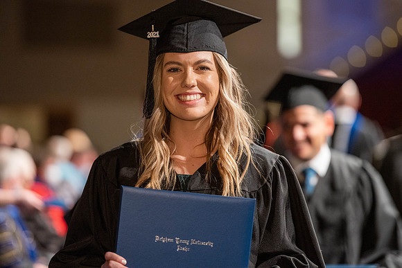 Combined Convocation for the College of Business & Communication and also the College of Physical Sciences & Engineering. Graduates receive their diploma covers.