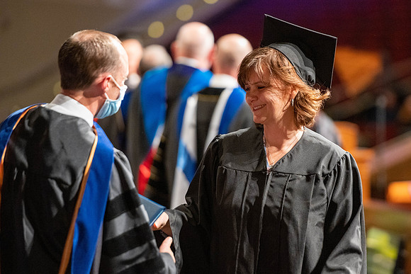 Combined Convocation for the College of Business & Communication and also the College of Physical Sciences & Engineering. Graduates receive their diploma covers.