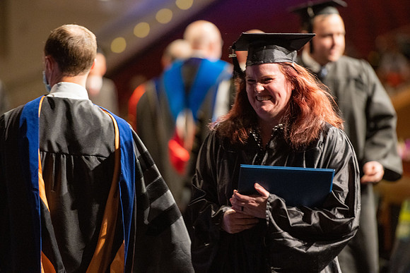 Combined Convocation for the College of Business & Communication and also the College of Physical Sciences & Engineering. Graduates receive their diploma covers.