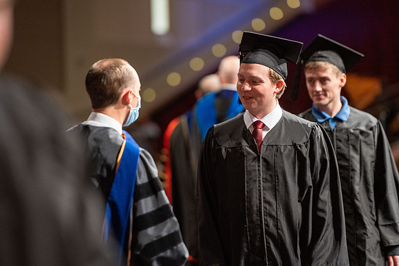Combined Convocation for the College of Business & Communication and also the College of Physical Sciences & Engineering. Graduates receive their diploma covers.