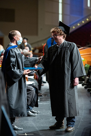 Combined Convocation for the College of Business & Communication and also the College of Physical Sciences & Engineering. Graduates receive their diploma covers.